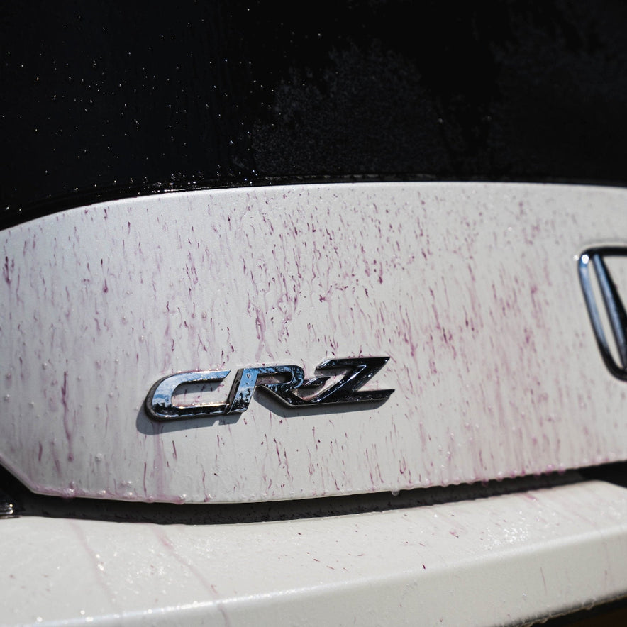 Purple Rain reacting on a boot of a car